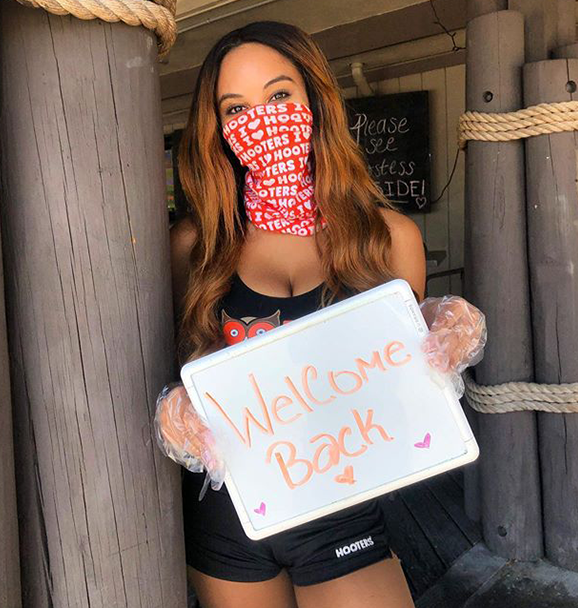 Hooters Girl welcomes guests at front door